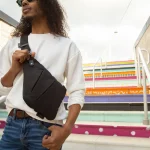 A man wearing the smell proof cross body bag over his front