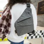 A man wearing the smell proof cross body bag over his back